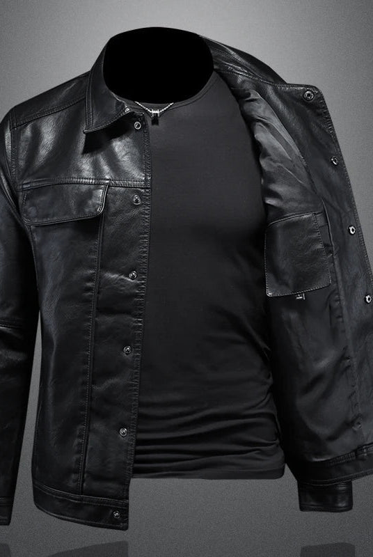 Black leather jacket over a black shirt on a gray background