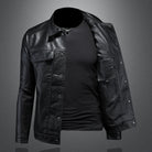Black leather jacket over a black shirt on a gray background