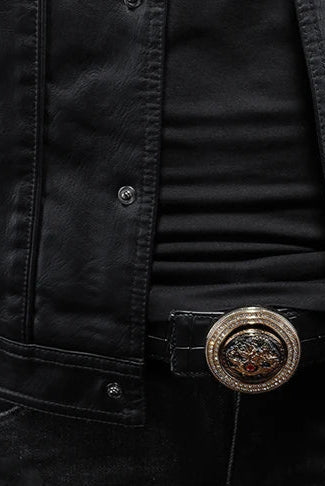 Close-up of a person wearing a black jacket with a decorative belt buckle.