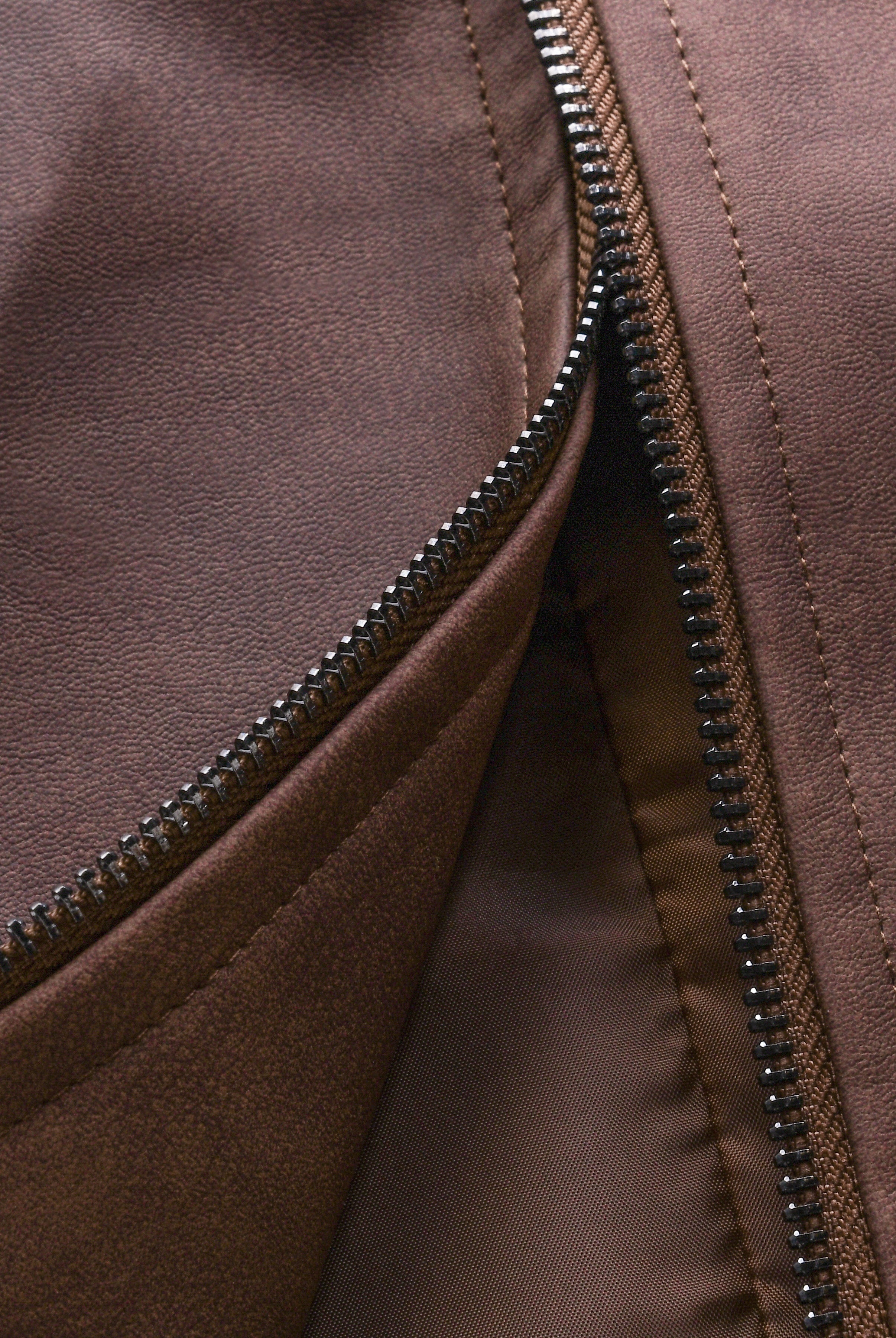 Close-up of a brown jacket with a zipper