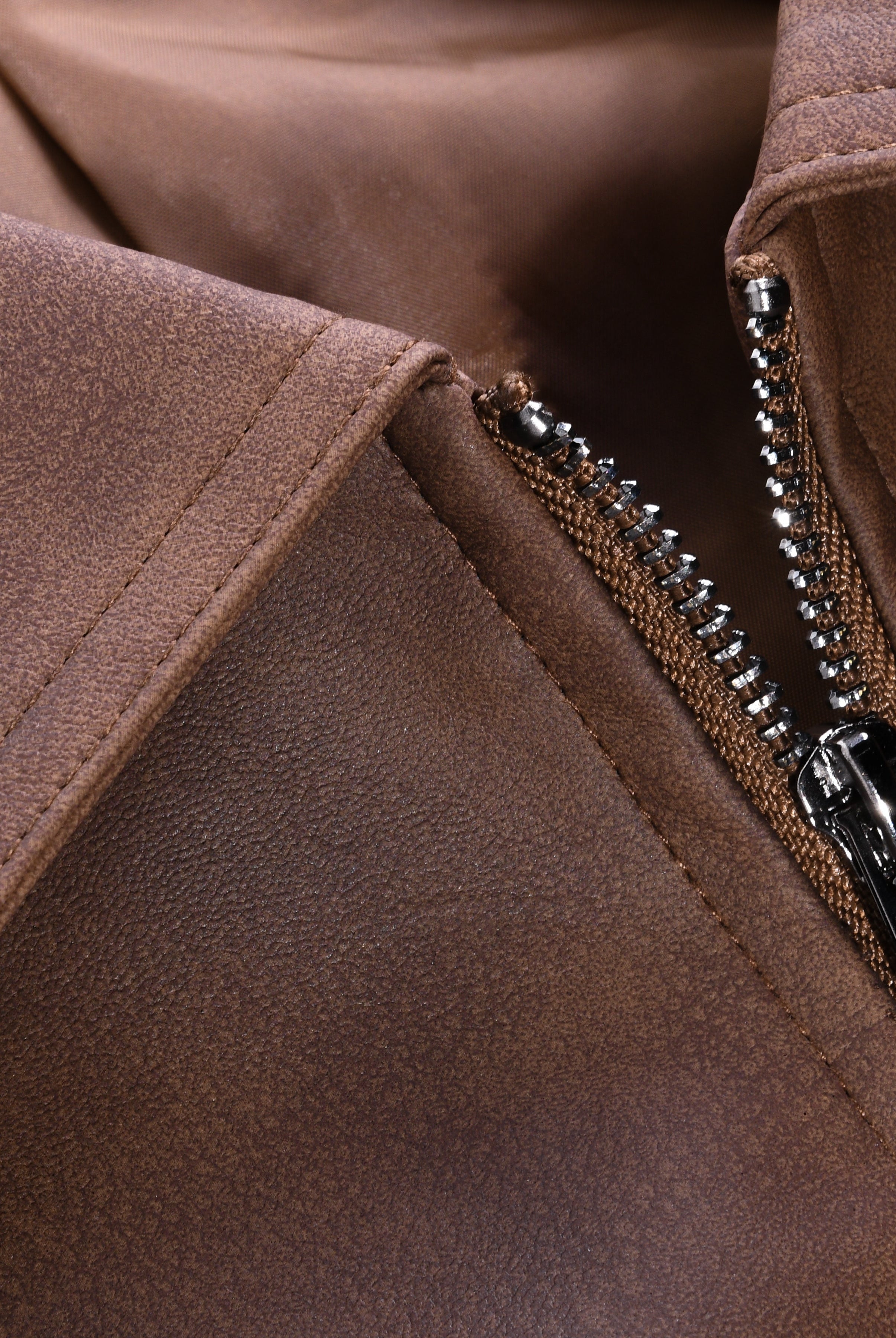 Close-up of a brown jacket with a zipper