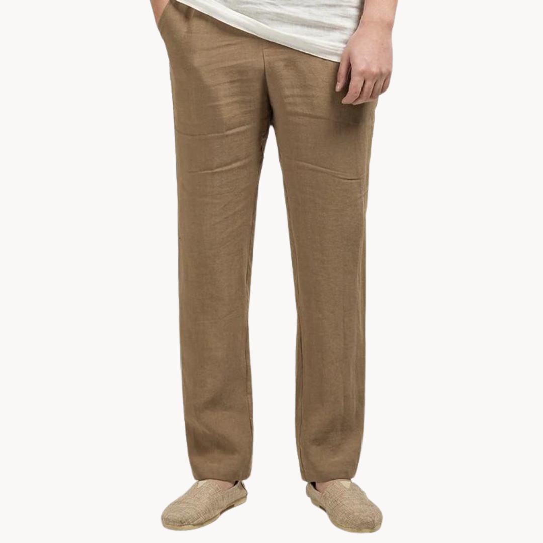 Person wearing beige linen pants on a white background