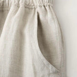 Close-up of a beige linen apron on a white background