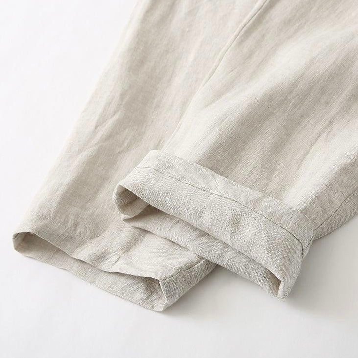 Folded beige linen cloth on a white background