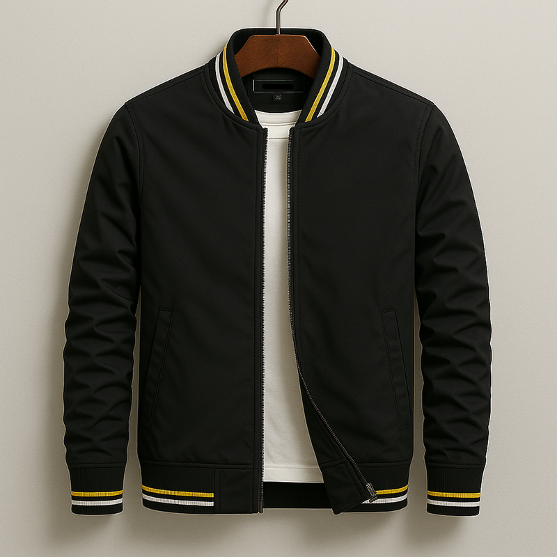 Black bomber jacket with yellow accents on a hanger against a beige background