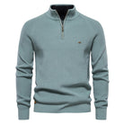 Light blue sweater with a quarter zip on a white background
