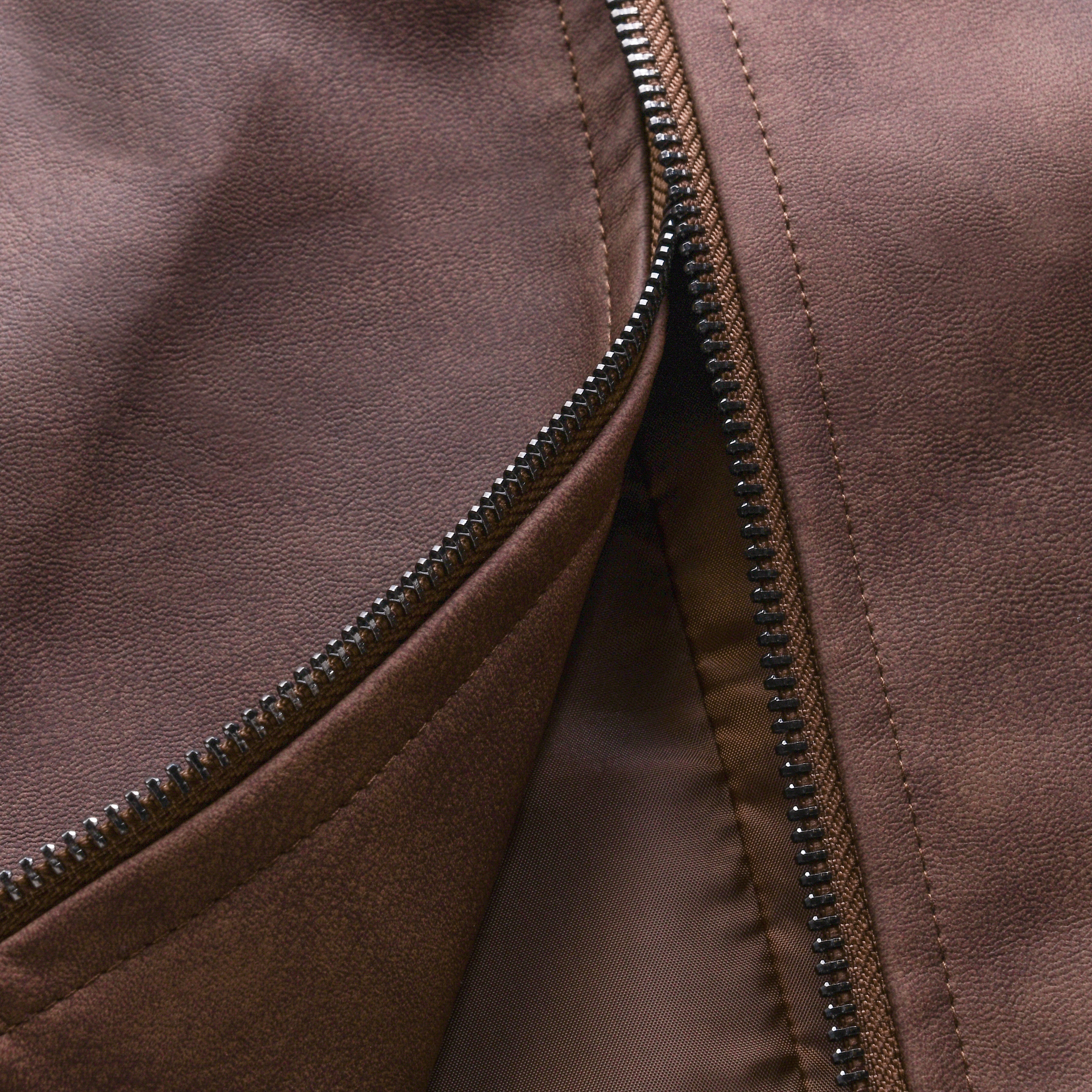 Close-up of a brown jacket with a zipper
