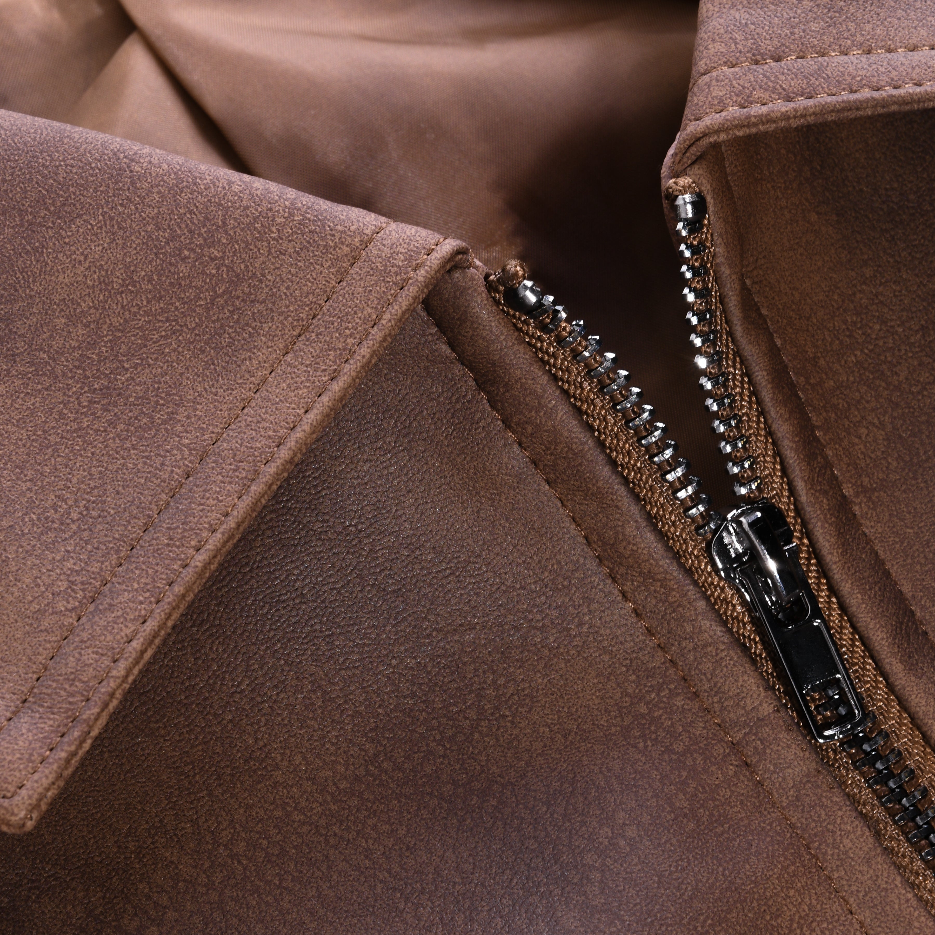 Close-up of a brown jacket with a zipper