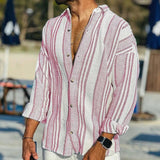 Man wearing a striped shirt with a blurred beach background
